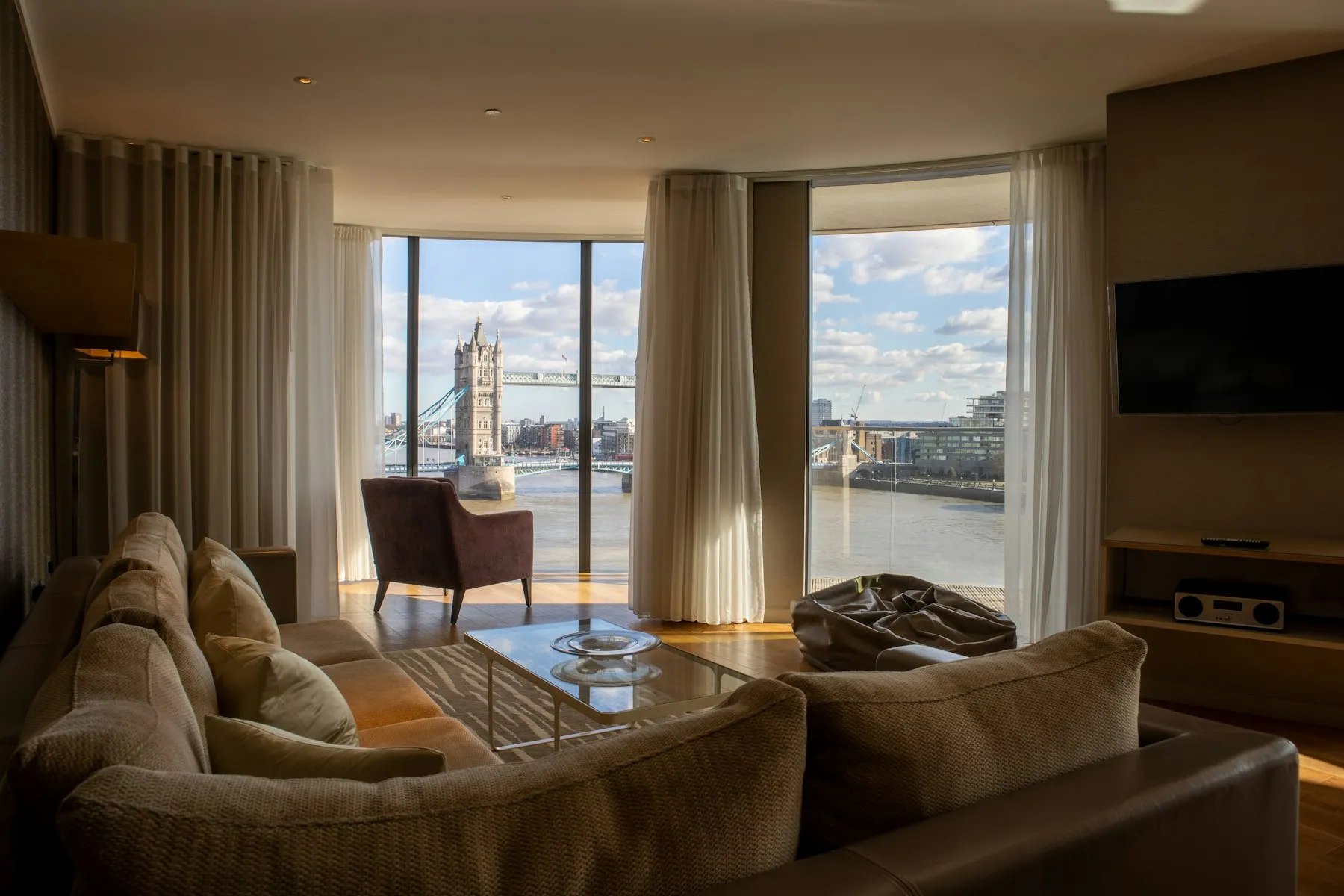 The living room, with a wide window looking across the Thames to Tower Bridge