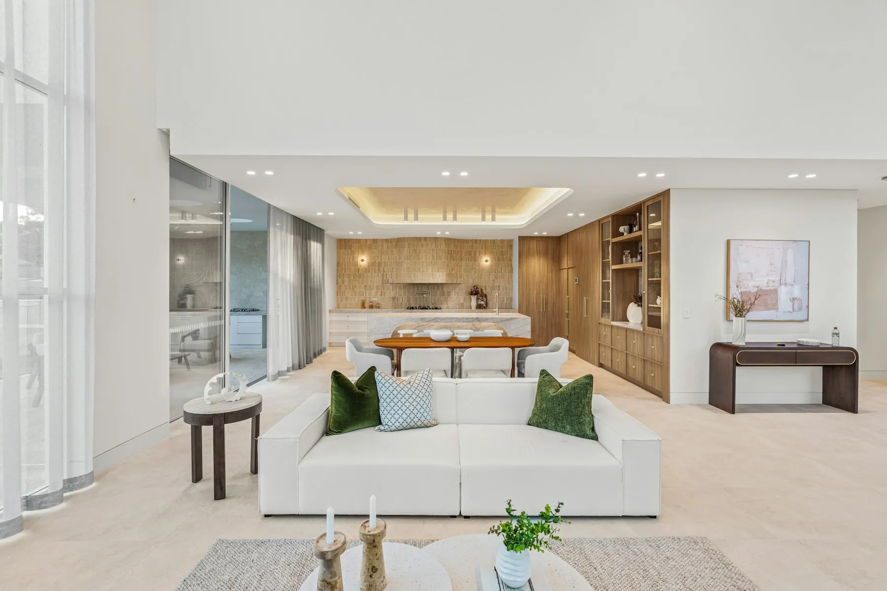 The open-plan living room, with a white sofa and a large rooflight above