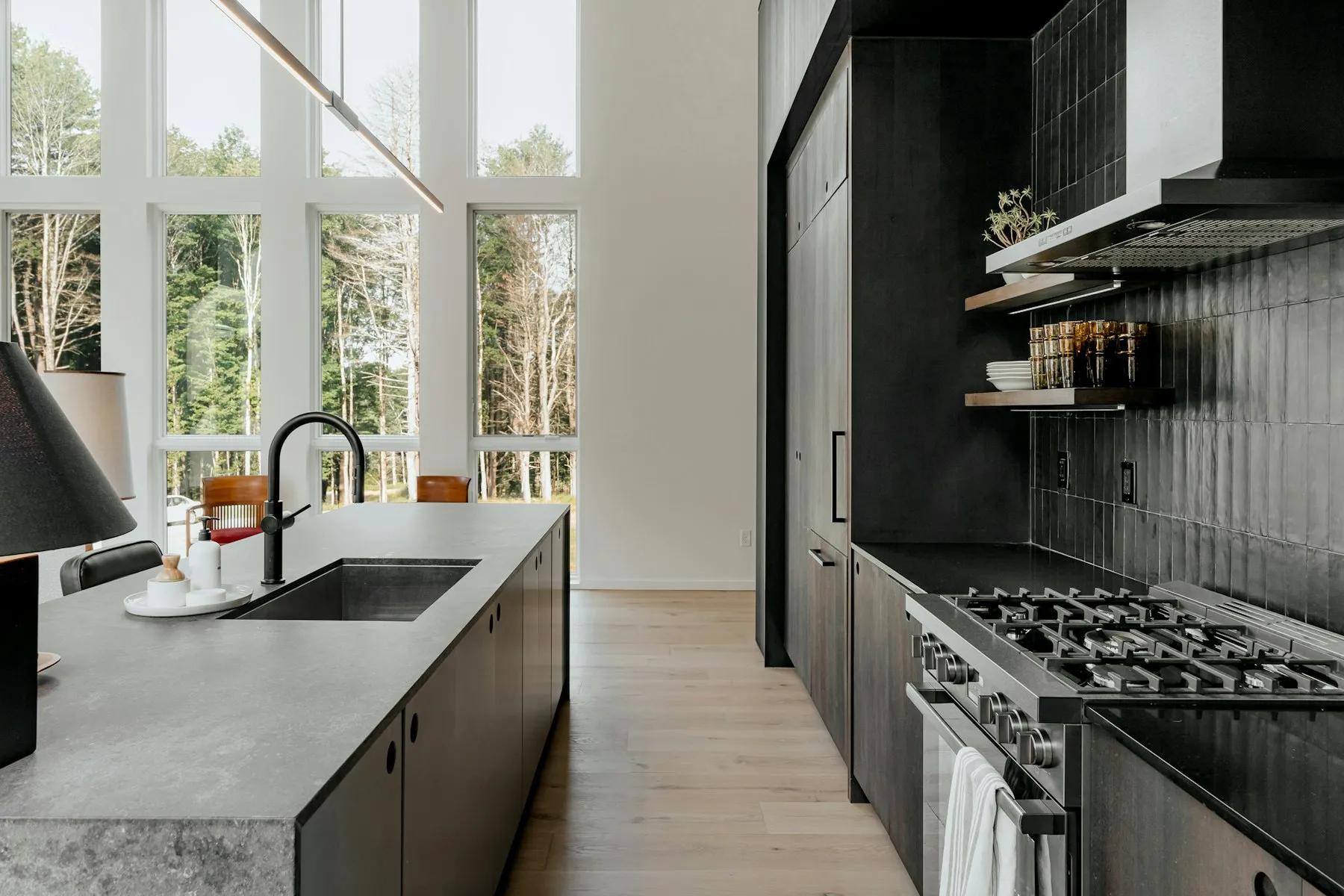 The kitchen, with dark cabinets, a concrete worktop and a range cooker
