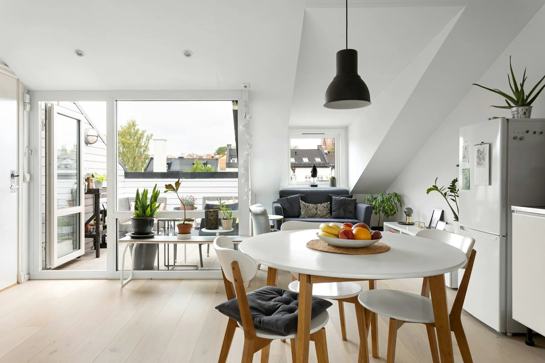 The kitchen and dining area, with a round white table and a door to the terrace