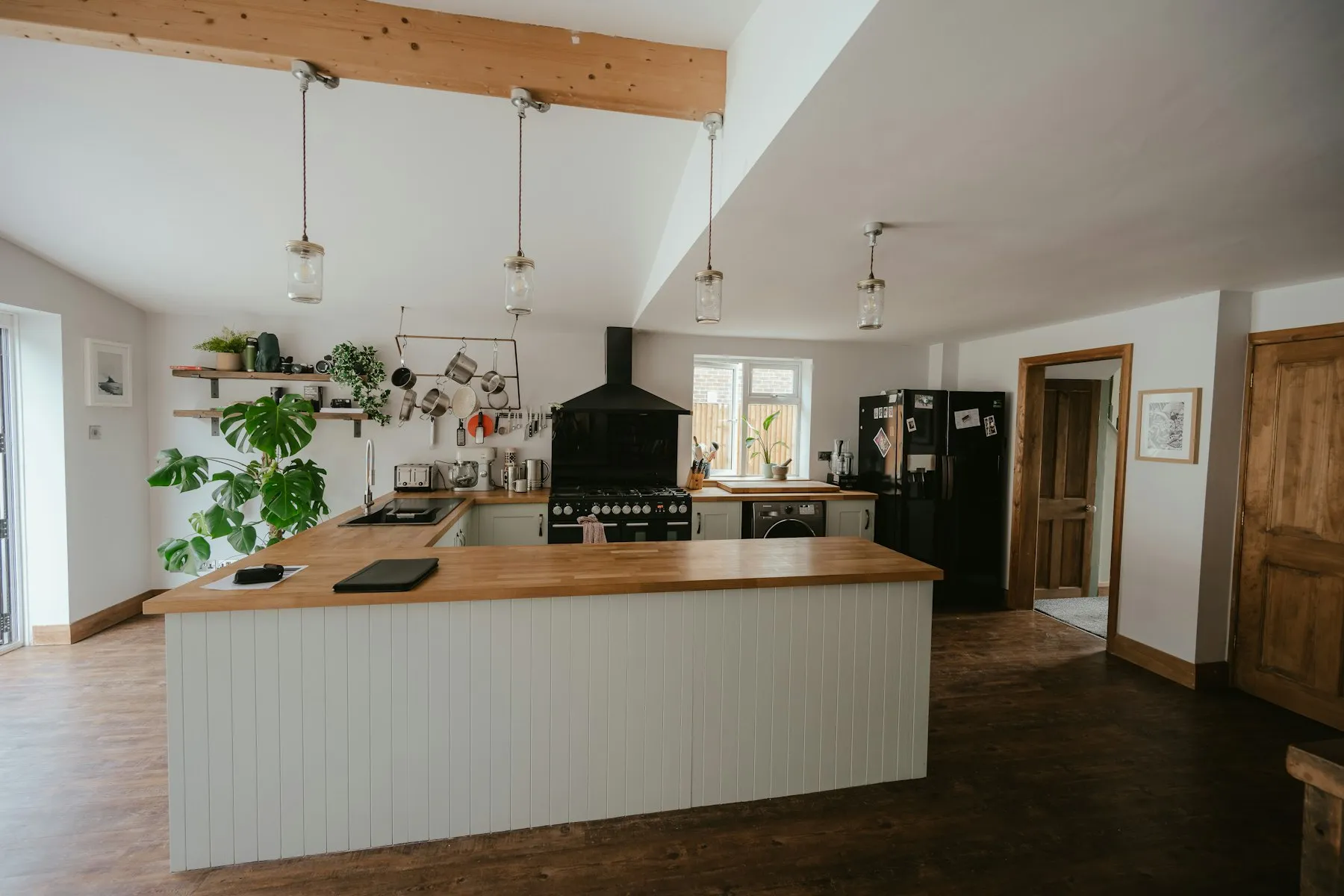 The kitchen, with a timber island, open shelves and a range cooker