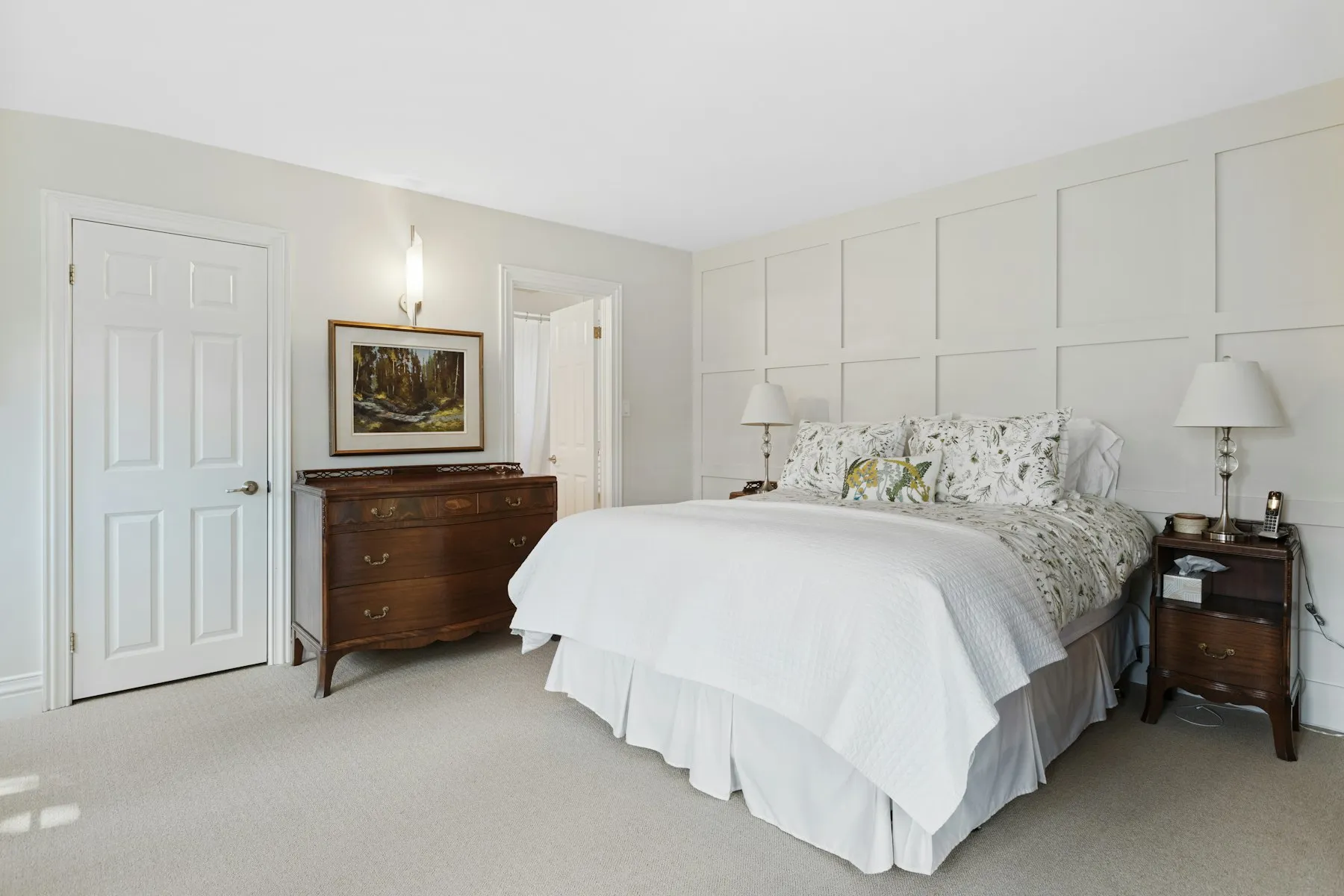 The principal bedroom, with panelled walls and a wide double bed