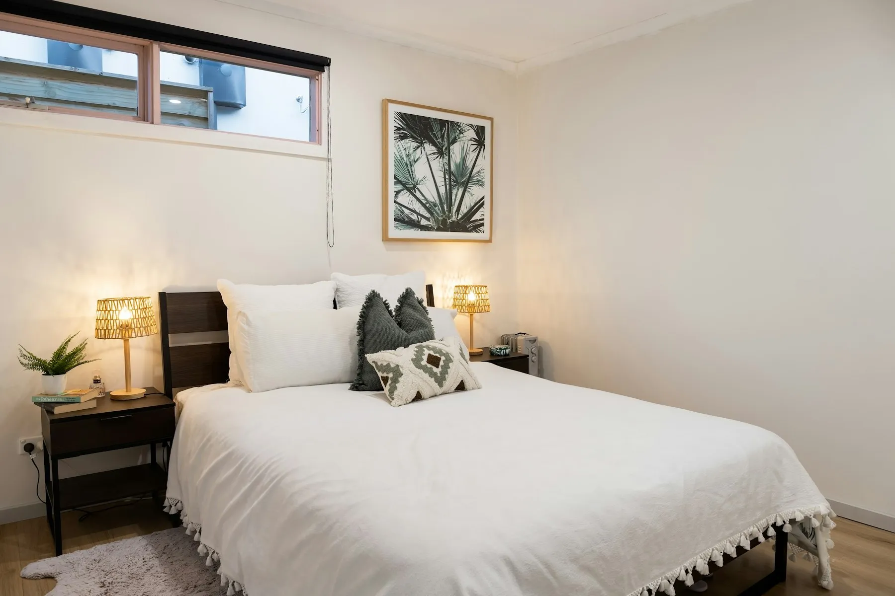 The principal bedroom in the loft, with a white double bed and a rooflight