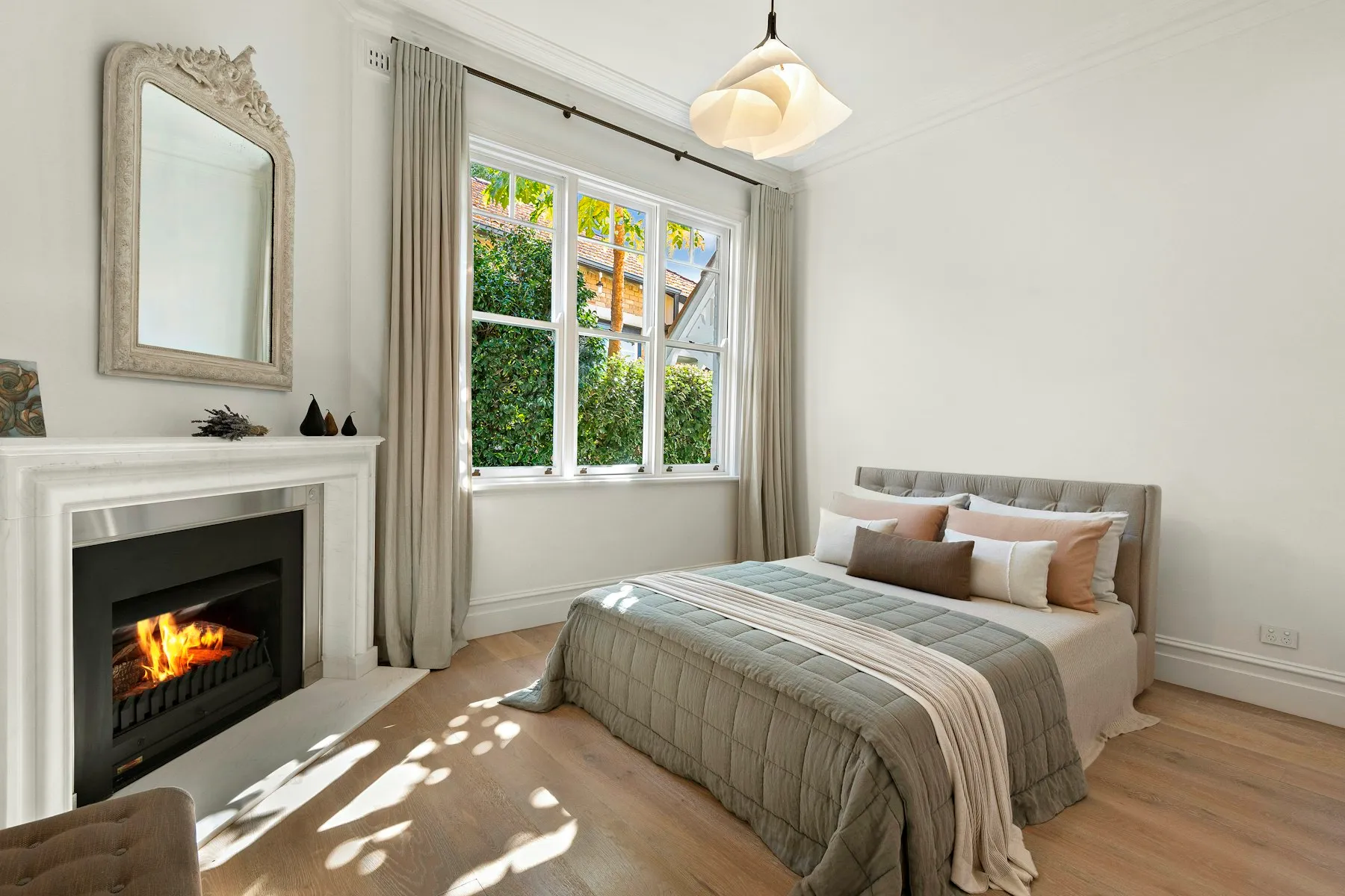 The principal bedroom, with a working fireplace and a window over the garden