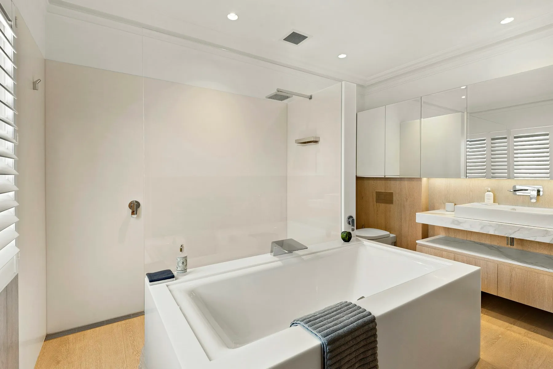 The en suite bathroom, with a freestanding bath and a walk-in shower