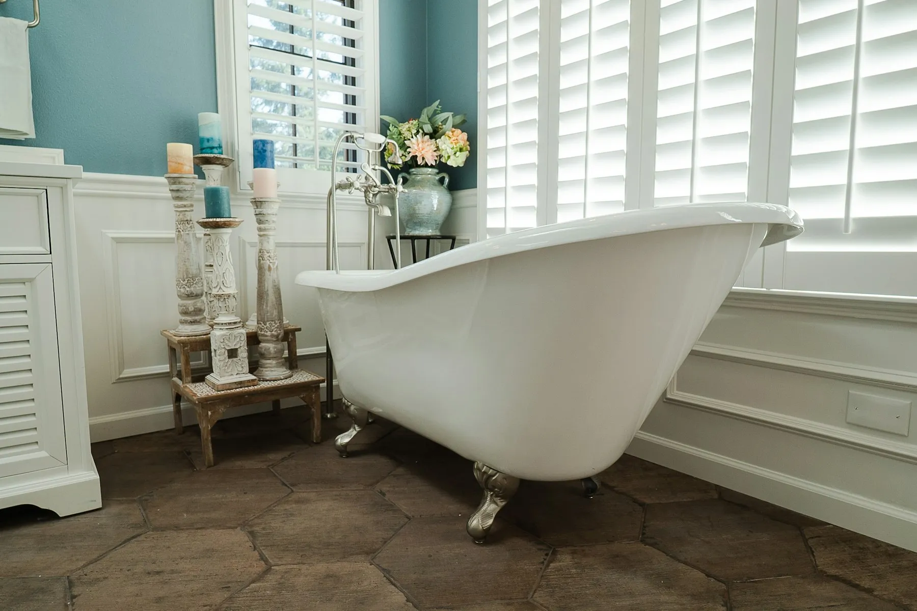 The bathroom, with a roll-top bath and plantation shutters