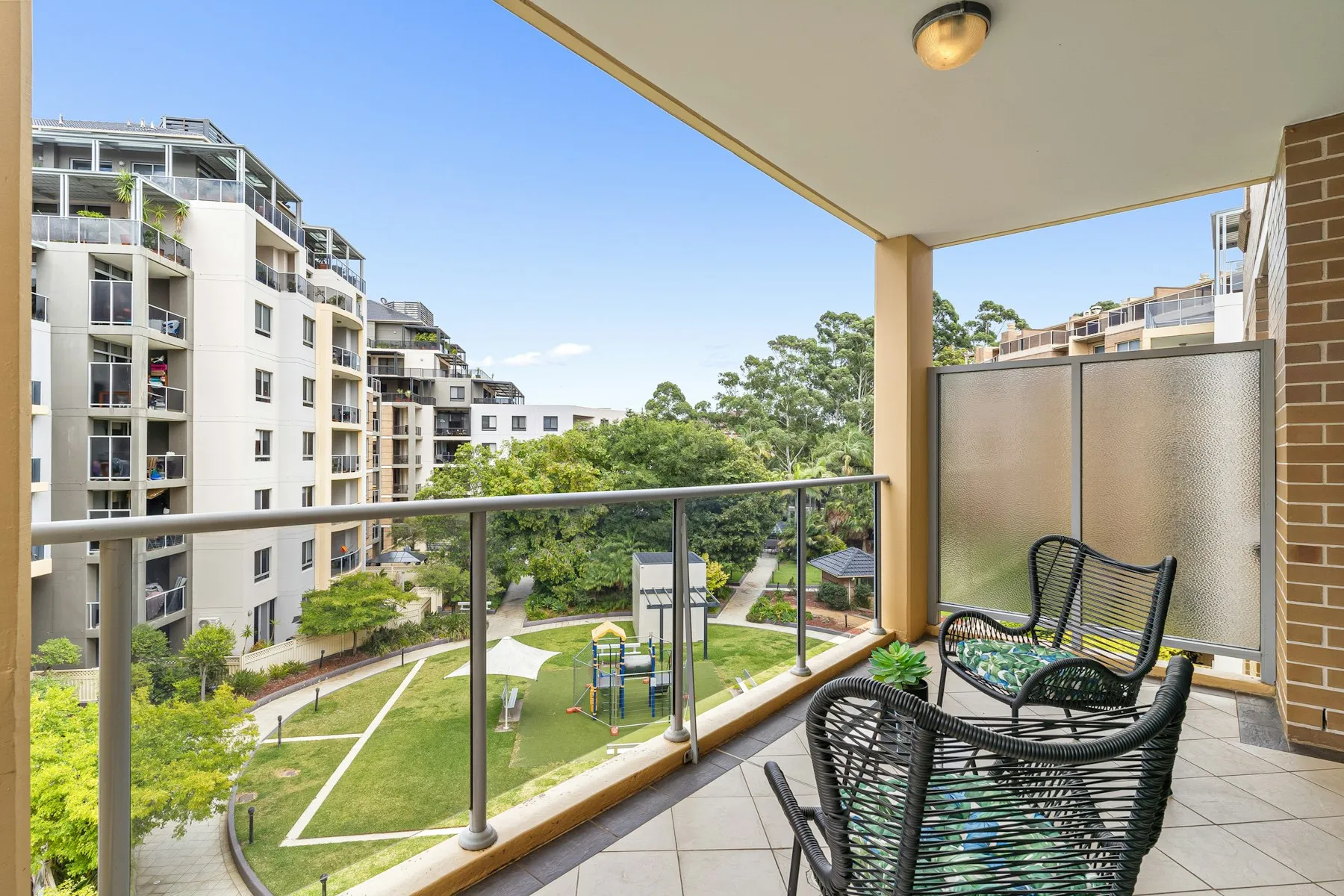 The balcony, with two chairs and a view over the landscaped gardens