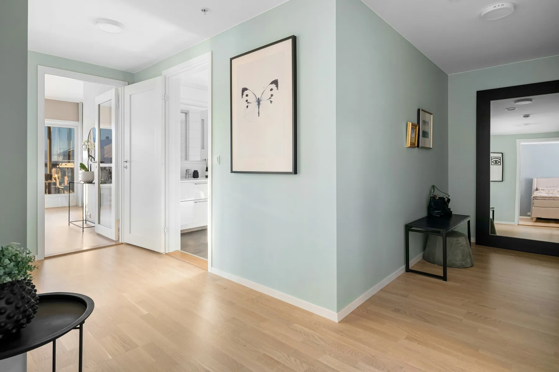 The landing, with pale green walls and oak floors