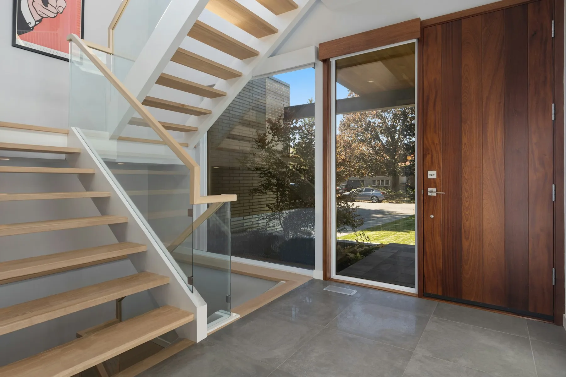 The entrance hall, with a floating oak and glass staircase