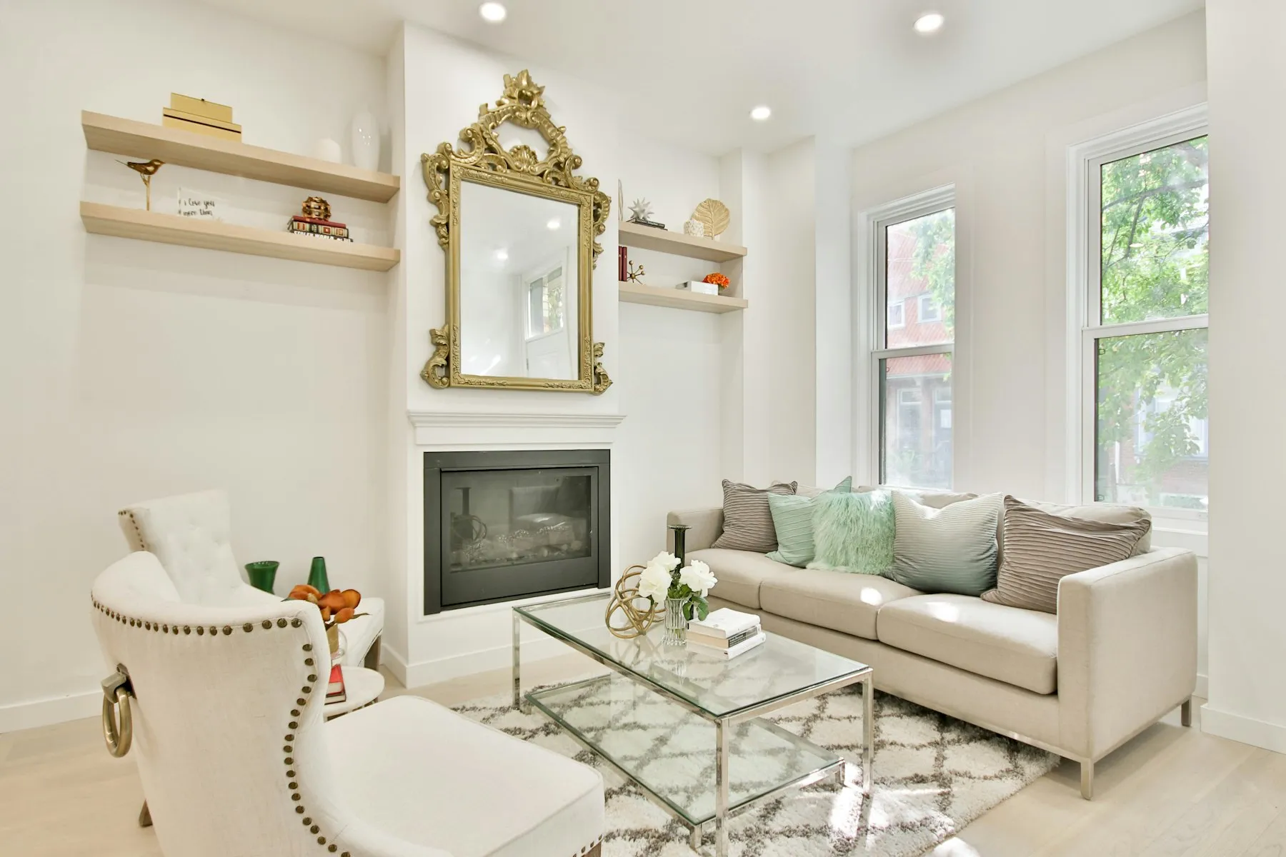 A second sitting room, with a gilt mirror over the fireplace