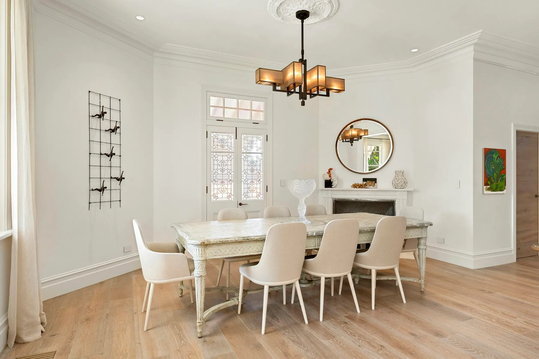 The dining room, with a long table under an iron chandelier