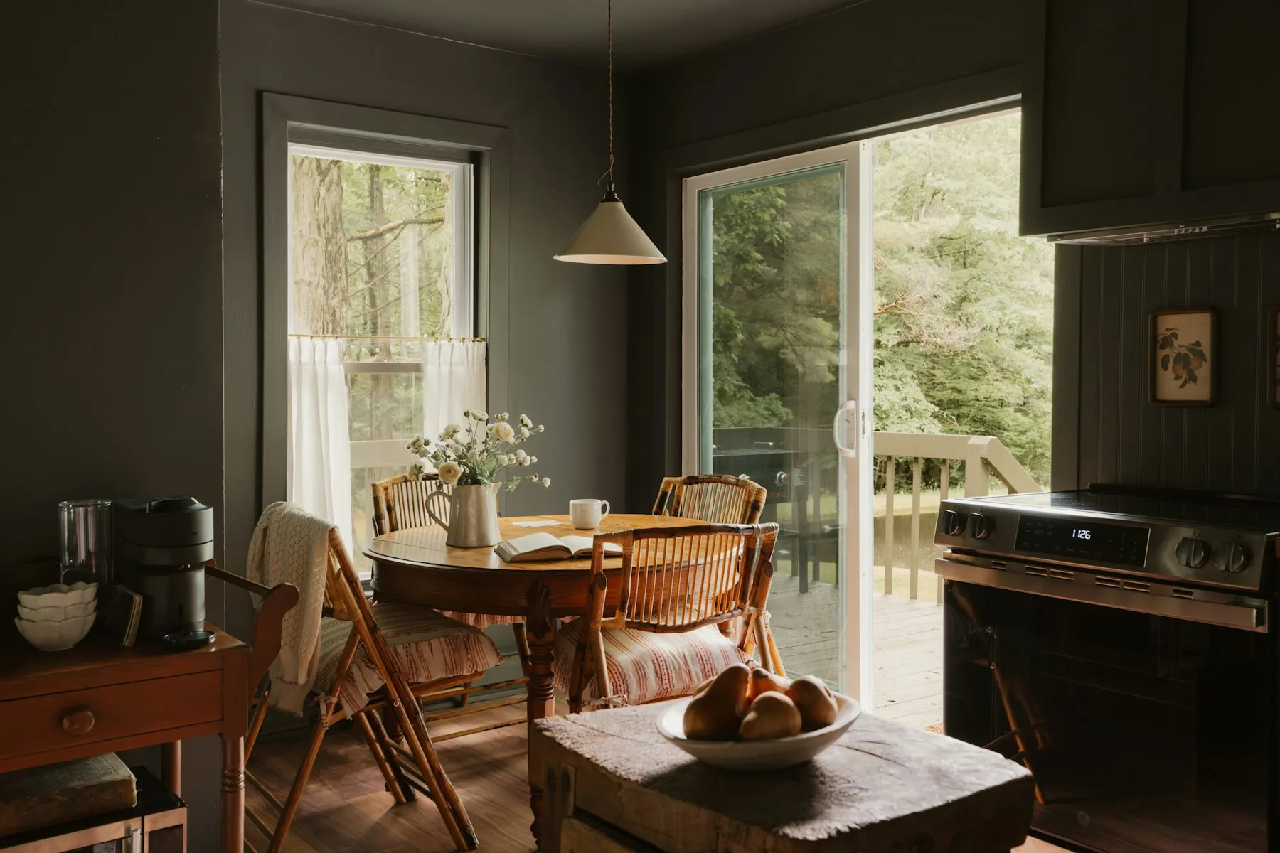 The dining corner, with a round table by glass doors to the garden