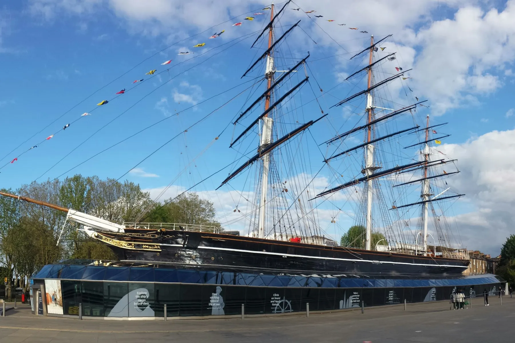 The Cutty Sark in dry dock at Greenwich, its masts strung with flags